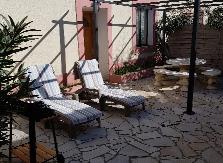 Private terrace with garden furniture and arbour of the winegrower's cottage le Merlot for rent at Château Borie Neuve in the Occitanie region